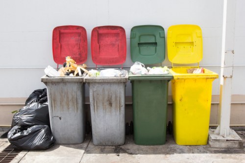 People disposing old furniture in West London recycling center